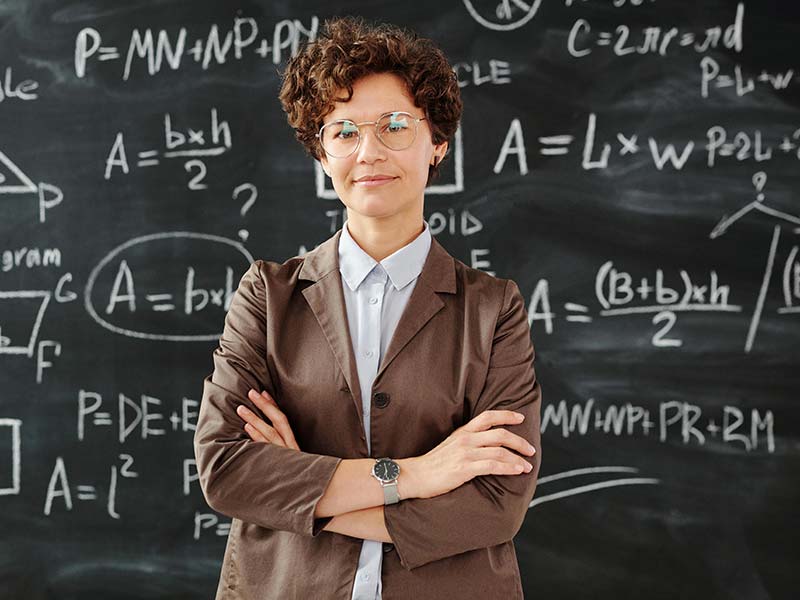 Teacher in front of blackboard